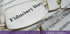 glasses with the words fiduciary duty in the lense on a piece of paper