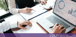 Two nonprofit professionals review financial reports and budget charts on a laptop while discussing public charity compliance and IRS reporting requirements. LFNP branding displayed at bottom of image.